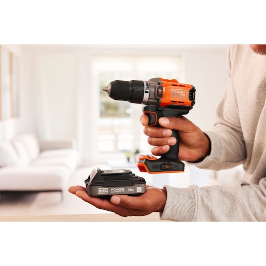 A battery pack being inserted into the BLACK+DECKER® POWERCONNECT™ 18V Cordless Hammer Drill.
