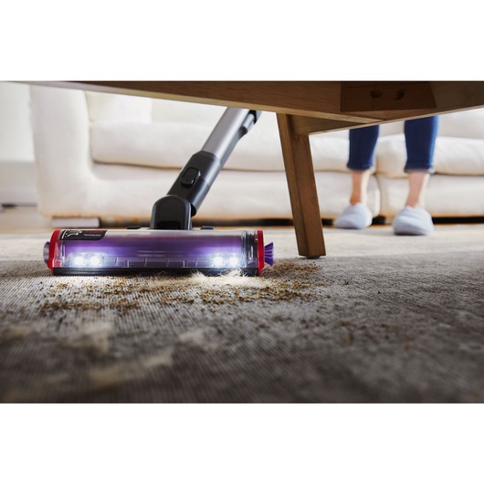BLACK+DECKER SUMMITSERIES cordless stick vacuum vacuuming debris under coffee table