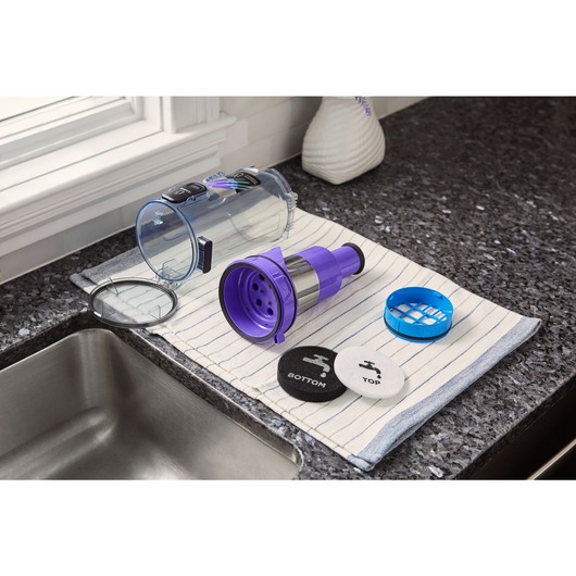 BLACK+DECKER SUMMITSERIES cordless stick vacuum filters and dustbin drying on towel by sink