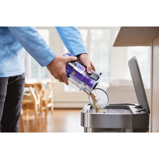 BLACK+DECKER SUMMITSERIES cordless stick vacuum dustbowl being emptied into trash can