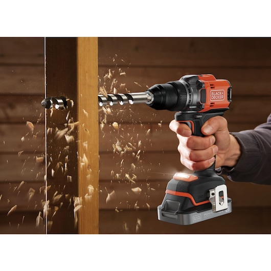 A wooden column being drilled into with an auger drill bit using the BLACK+DECKER® 18V POWERCONNECT™ Brushless Drill Driver.