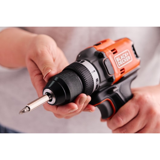 A hand adjusts the chuck of the BLACK+DECKER® 18V POWERCONNECT™ Brushless Drill Driver.