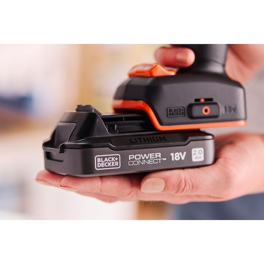A POWERCONNECT™ battery pack being inserted into the BLACK+DECKER® 18V Brushless Hammer Drill.