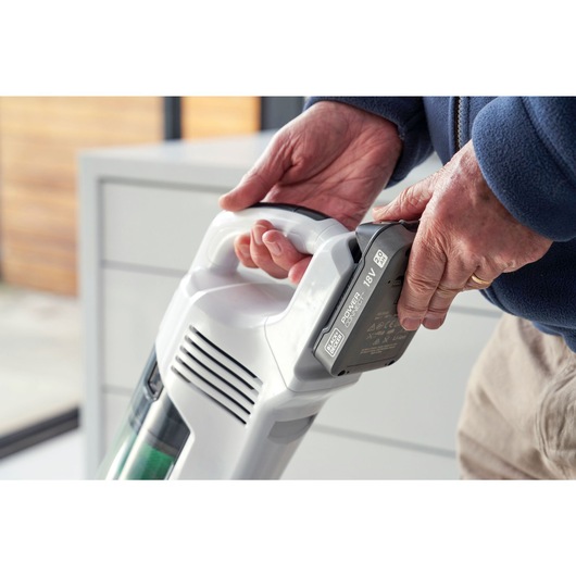 A POWERCONNECT™ battery being inserted into the BLACK+DECKER® reviva™ 18V POWERCONNECT™ Cordless Stick Vacuum.